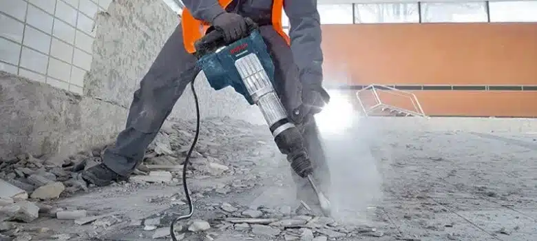 Breaking thick industrial concrete floor pavement using excavator rock breaker
