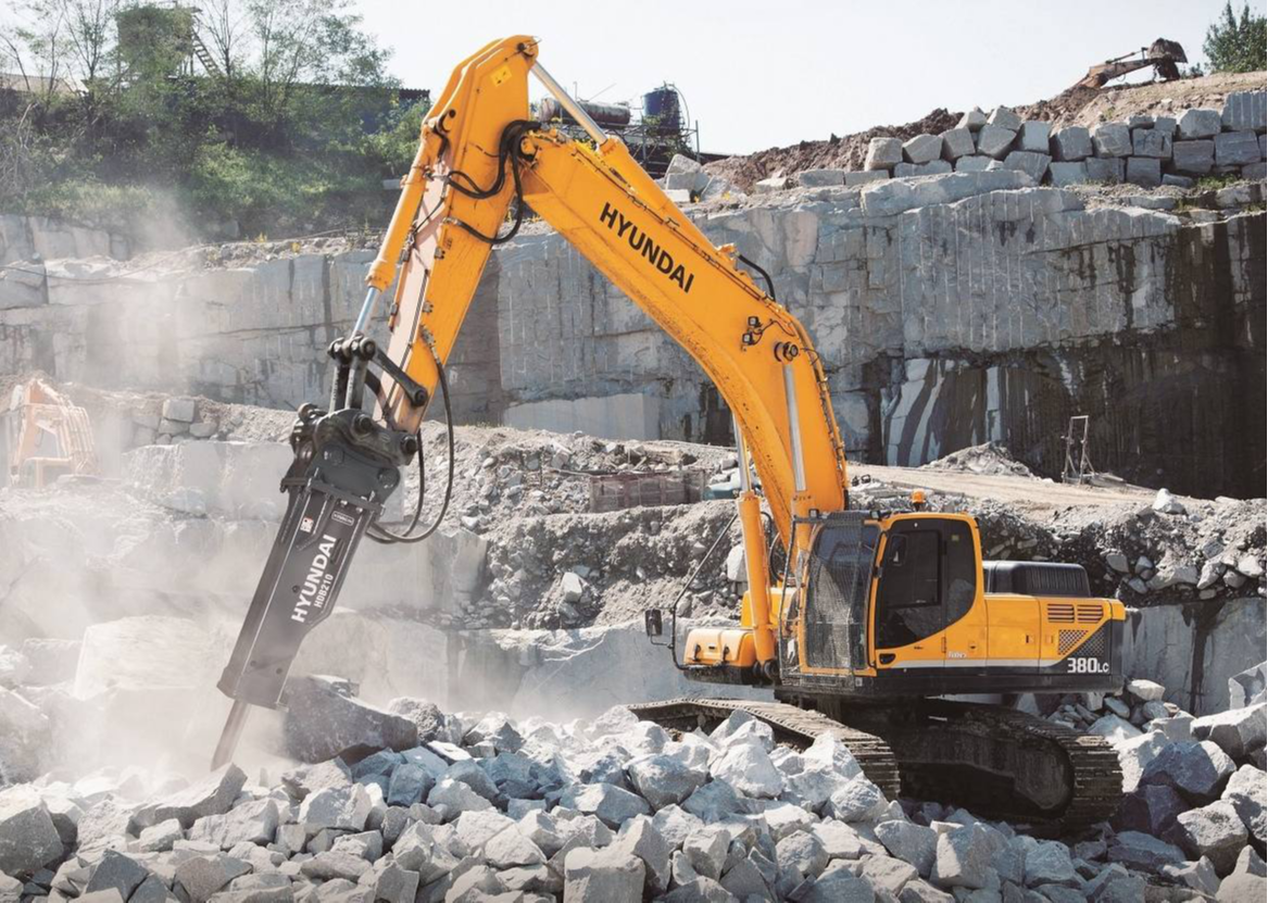 Medium hydraulic breaker breaking concrete slabs and utility trenches